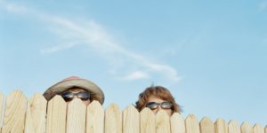 Two women looking over fence